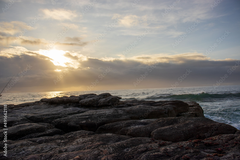 Seascape view with people fishing from the shore line on the South Coast of South Africa Seascape view with people fishing from the shore line on the South Coast of South Africa