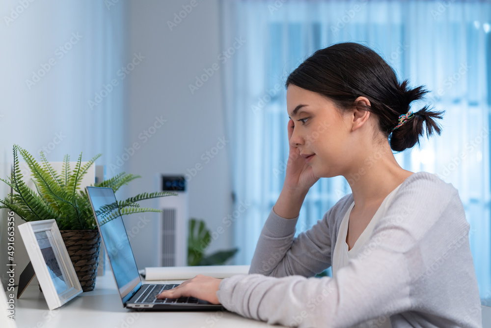 Asian young woman study virtual online and work in living room at home. Asian young woman study virtual online and work in living room at home.