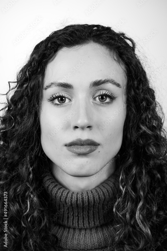 Black and white portrait of a beautiful brunette girl with hazel eyes and square jaw and chin.