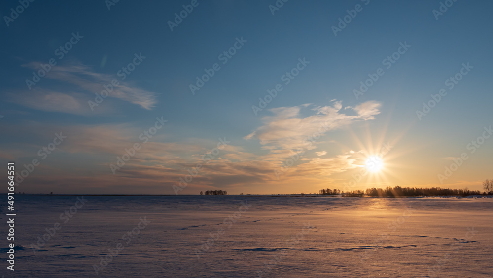 winter sunset on a snowy lake