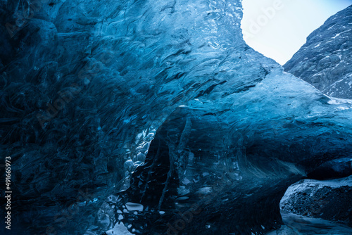 Interior of a glacial cave with a beautiful blue color, copy space. 