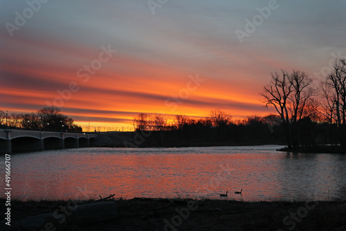 The sun rises over the bridge and the Maumee River in Waterville Ohio.