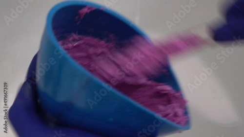 orthopedist mixing impression material in silicone mold