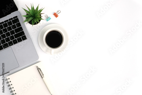 Workspace office business and education concept on white table desk background with laptop computer and blank notepad  coffee cup and green plant  calendar  Top view with copy space  flat lay