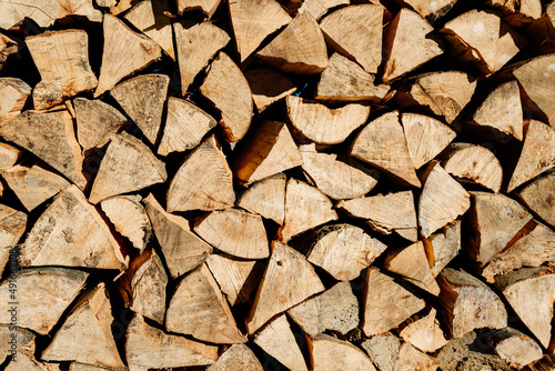 Stacked firewood texture background. Firewood natural