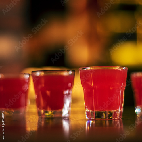 glass of alcohol shots on blurred background cube