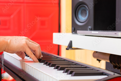 close up male musician hands playing midi piano for arranging music or practicing piano lesson