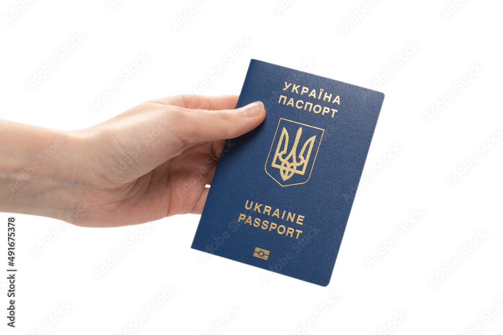 Ukrainian biometric passport in woman hand. Ukrainian biometric passport in woman hand.