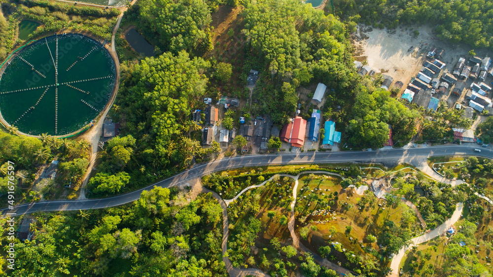 Obraz premium Aerial view of countryside road and village in the morning at Thailand