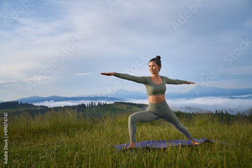 Attractive young woman with dark hair having outdoors training during morning time. Concept of people  workout and active lifestyles.