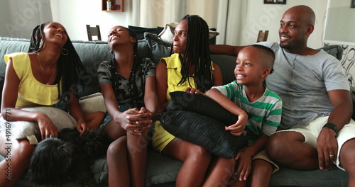 Fototapeta Naklejka Na Ścianę i Meble -  Candid authentic black African family together in living-room sofa