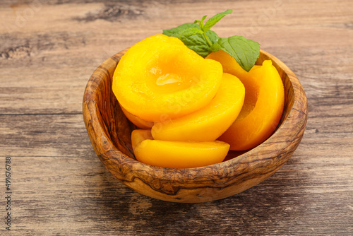 Sweet ripe canned peaches with mint