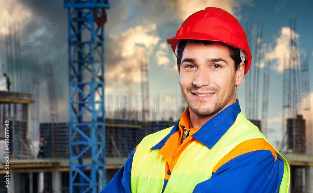 Bricklayer man poses smiling while renovating a building construction Bricklayer man poses smiling while renovating a building construction