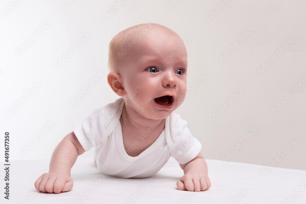upset baby crying on a white isolated background upset baby crying on a white isolated background