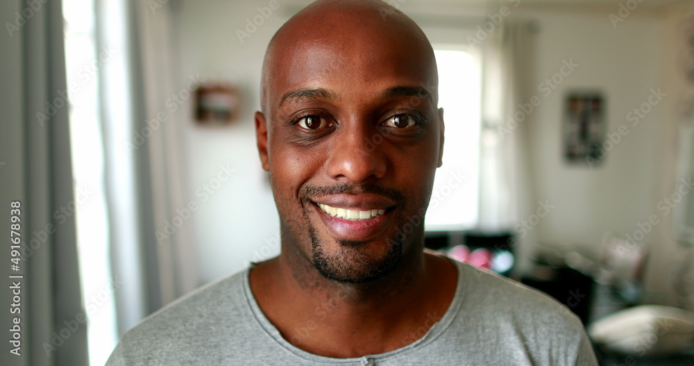 Black mixed race man smiling at camera indoors at home, casual person real people series Black mixed race man smiling at camera indoors at home, casual person real people series