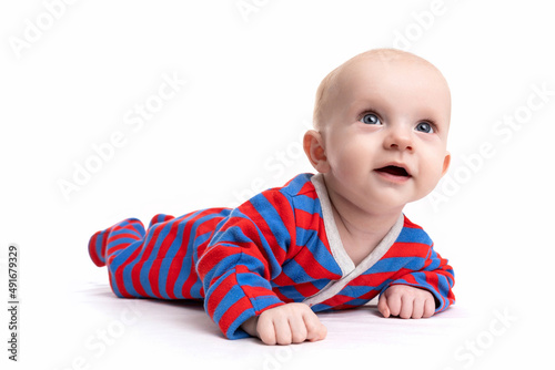 cute baby in a striped bodysuit on a white isolated background looks up