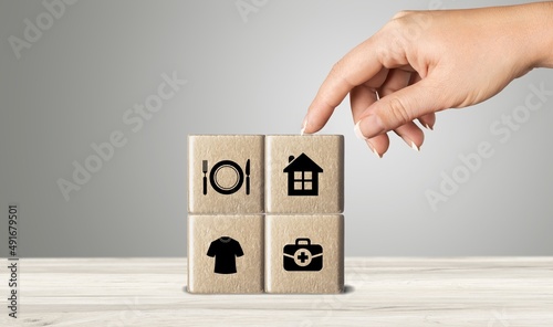 The investor's concept, wooden cube with concept work from home, Planning to buy property concept ,food Clothing, housing, medicine, four basic human needs concept.