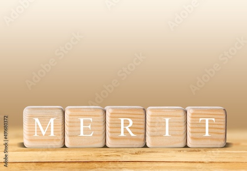 Obraz na płótnie Wooden blocks for MERIT text of concept.