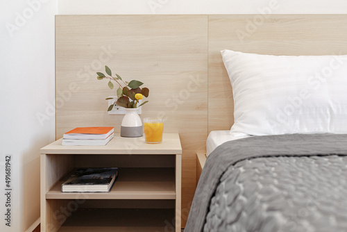 bedside table with flowers and books
