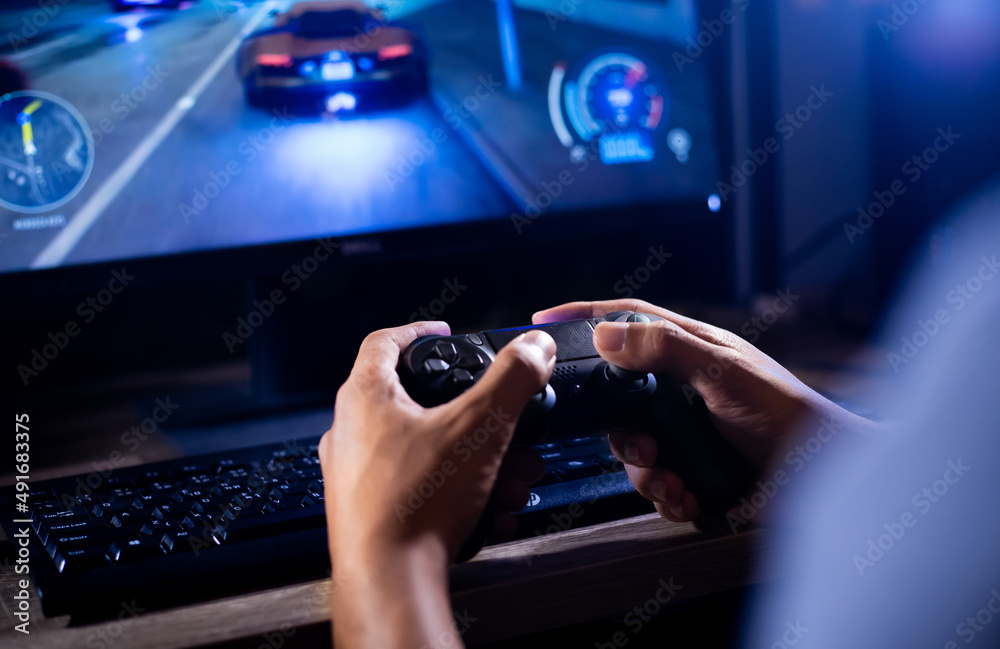 close up hand of young man playing video game holding controller close up hand of young man playing video game holding controller