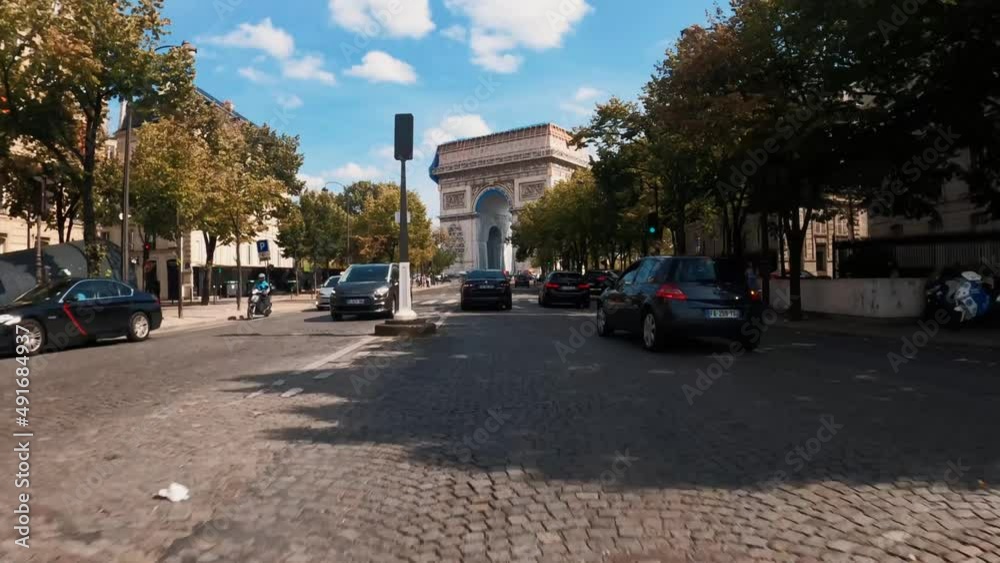 Point of view car driving towards The Arc de Triumph Paris streets architecture view, Paris France 