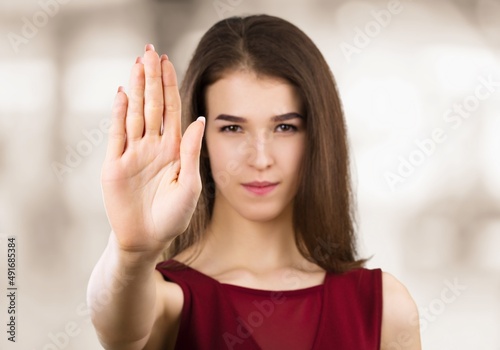 Young female extend hand with stop symbol gesture oppose against domestic sexual violence abuse racial gender discrimination.