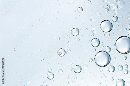 champagne bubbles or cosmetic liquid water bubbles floats drops surface over a blurred background