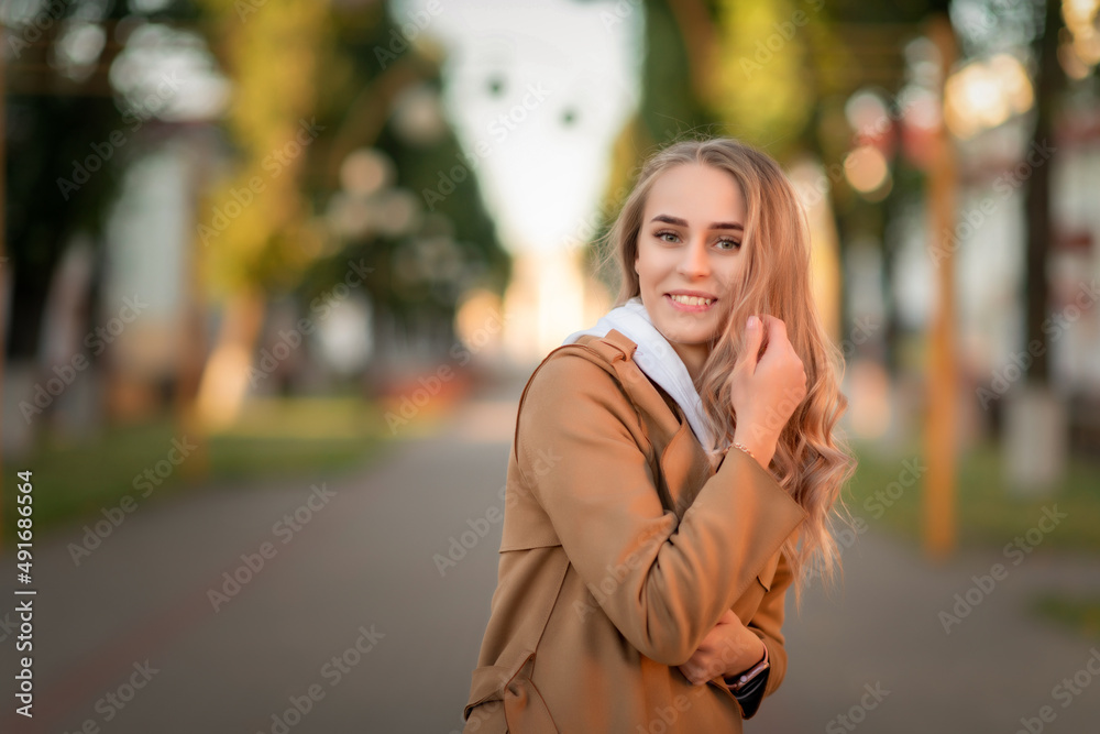 Portrait of a young beautiful fair-haired girl on a summer street. Portrait of a young beautiful fair-haired girl on a summer street.