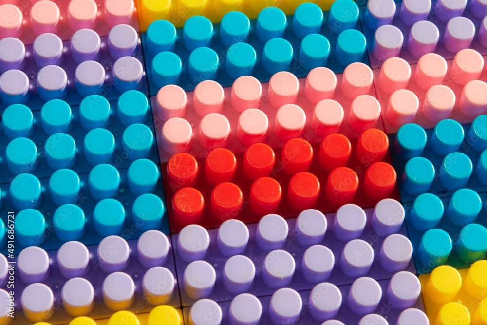 children's play background: the plane of plastic multi-colored bricks, blur, selective focus children's play background: the plane of plastic multi-colored bricks, blur, selective focus