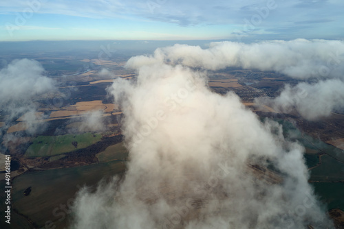 Aerial view from high altitude of earth covered with puffy rainy clouds forming before rainstorm