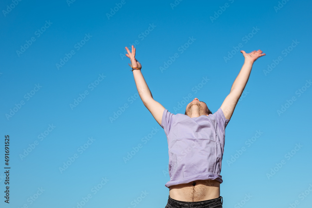 Unrecognizable man with raised arm in nature Unrecognizable man with raised arm in nature