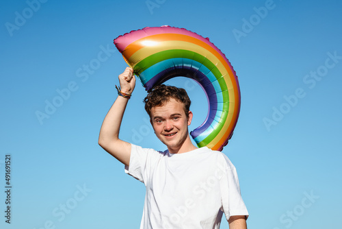 Cheerful man with LGBT balloon