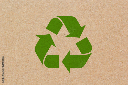 Recycle symbol on brown paper texture background