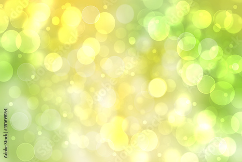 Hello spring background. Abstract bright spring or summer landscape texture with natural green yellow bokeh lights and sunshine. Beautiful backdrop with space.