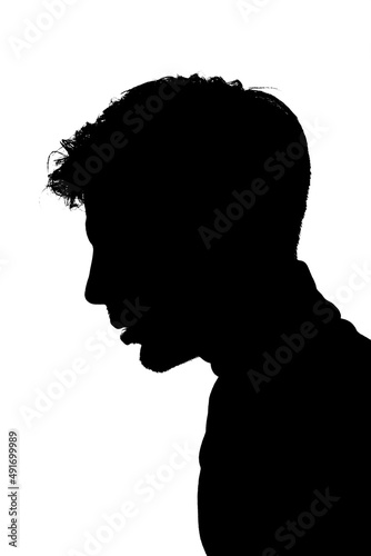 Backlit silhouette of a young man in profile. Cut out on white background.