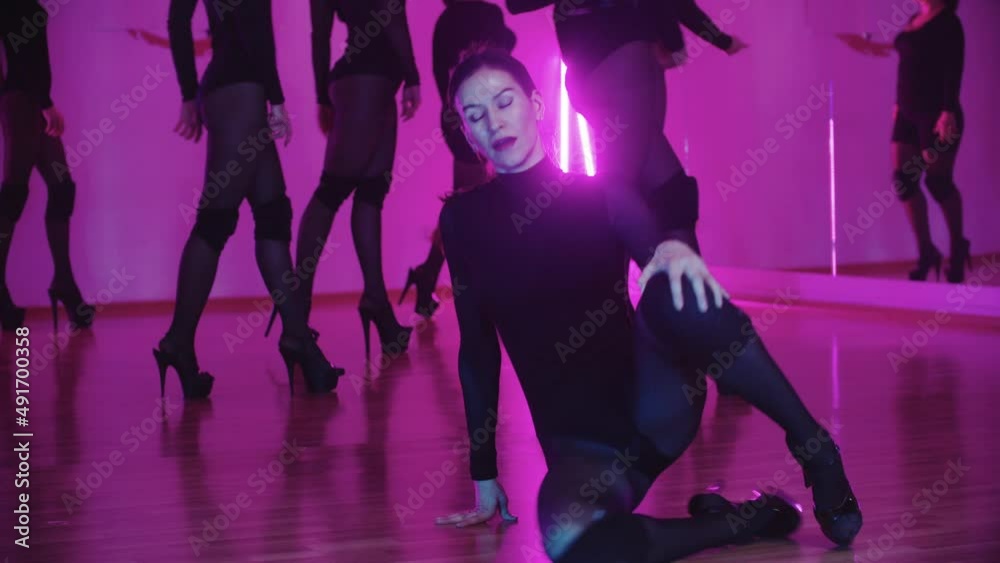 A woman dancer walks forwards and lying down on the floor with dance movements A woman dancer walks forwards and lying down on the floor with dance movements
