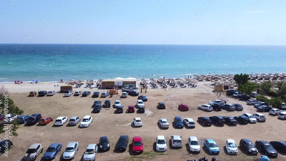Crowd on beach parking on sunny weekend. Luxury resort with tourists Crowd on beach parking on sunny weekend. Luxury resort with tourists