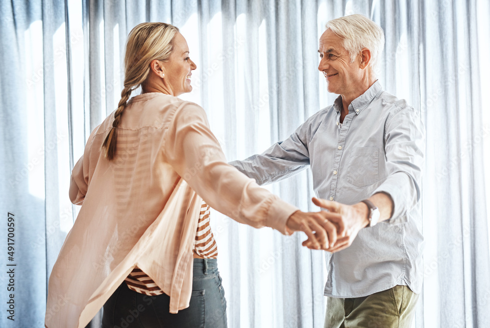Dancing the day away. Cropped shot of an affectionate mature couple dancing in their home. Dancing the day away. Cropped shot of an affectionate mature couple dancing in their home.