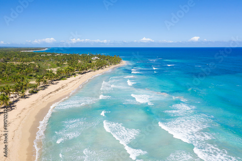Fototapeta Naklejka Na Ścianę i Meble -  Wild tropical coastline with coconut palm trees and turquoise caribbean sea. Travel destination. Aerial view