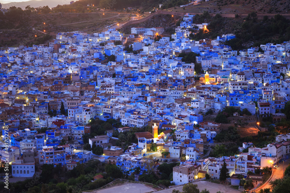 Aerial evening view of Chefchaouen in Morocco. The city is noted for its buildings in shades of blue and that makes Chefchaouen very attractive to visitors.