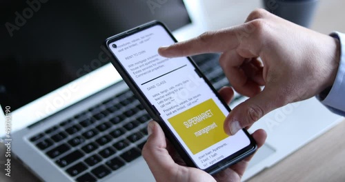 businessman reading newspaper on smartphone  screen