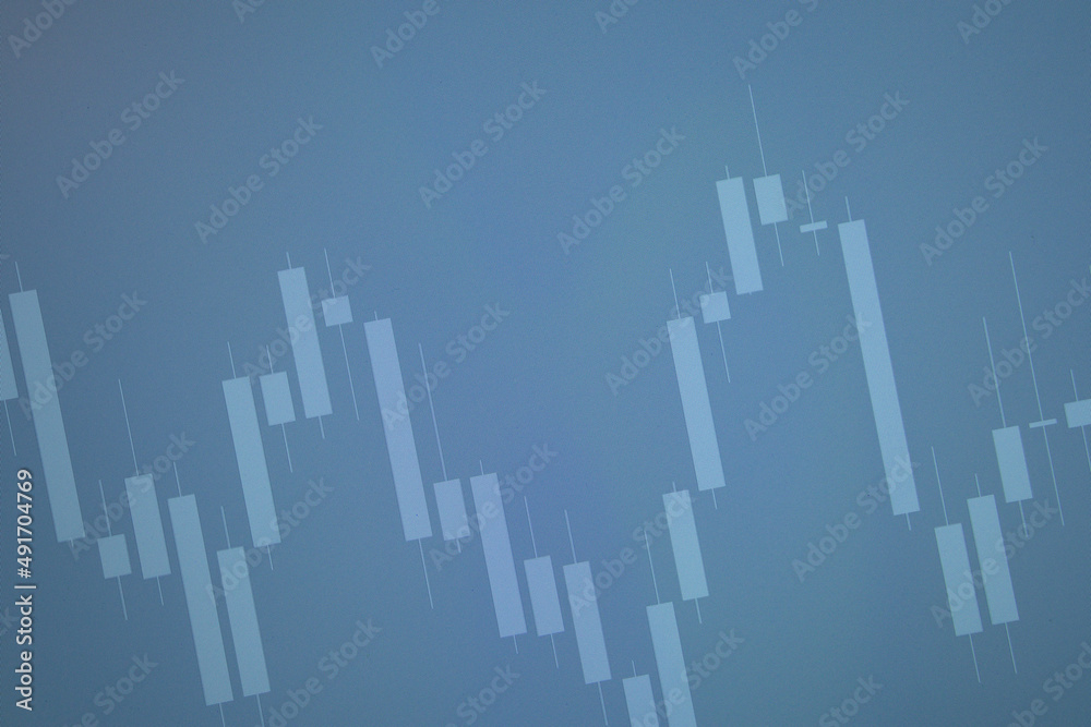 Blue background with a market candle bar chart on the screen. Stock, currency and commodity market concept. Economic background