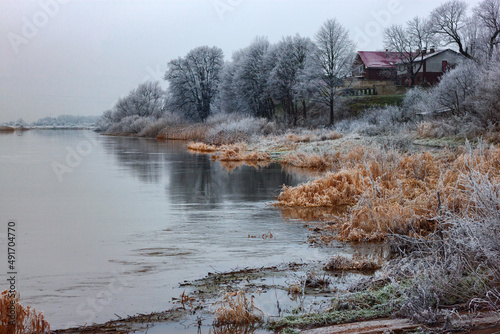 View of the river with frozen banks in winter photo