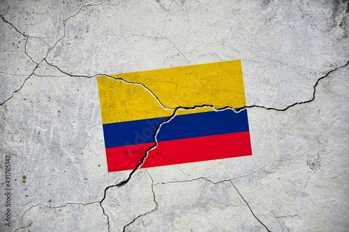 An old image of the flag of Colombia on a wall with a crack.