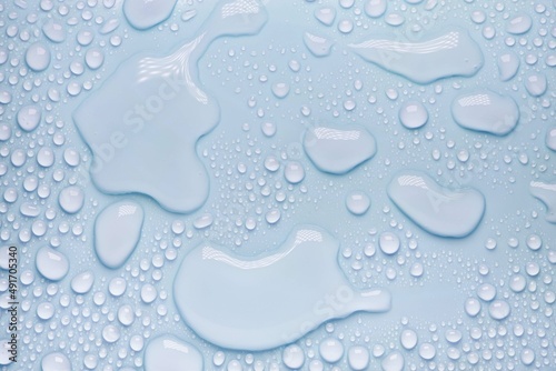 Bilde på lerret Cosmetic moisturizing liquid drops on blue pastel background