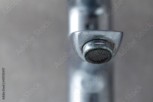 irty rusty faucet with limescale