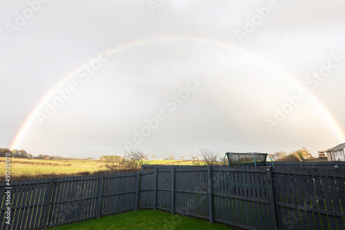 A very colourful rainbow arched over the Perceton fields against a gray sky just before the heavy rain fall. photo