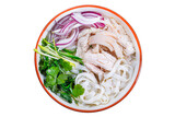 pho soup with noodles and chicken meat, fresh greens, on a plate, Vietnamese cuisine, homemade food, on a white isolated background, top