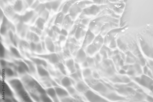 Fototapeta Naklejka Na Ścianę i Meble -  Splash cosmetic moisturizer water micellar toner or emulsion gray colored abstract background