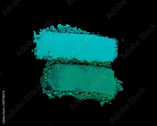 Eye shadow glitter shimmer and matte emerald green colored texture background dlack isolated photo